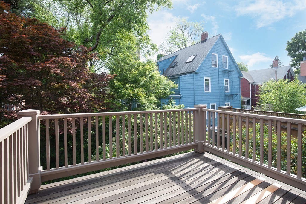 20 Maynard Place Cambridge, MA 02138 - Photo 8 of 10 a view of a brick house with wooden fence
