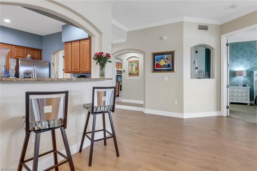 1296 Verde Drive, Unit 3 Naples, FL 34105 - Photo 11 of 31 a view of kitchen with furniture and wooden floor