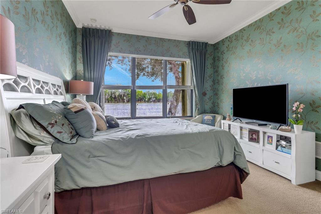 1296 Verde Drive, Unit 3 Naples, FL 34105 - Photo 13 of 31 a bedroom with a bed and a flat screen tv