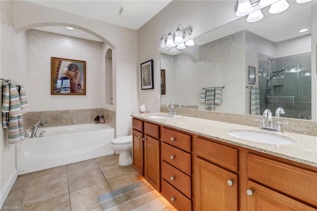 1296 Verde Drive, Unit 3 Naples, FL 34105 - Photo 14 of 31 a spacious bathroom with a tub double sink and mirror