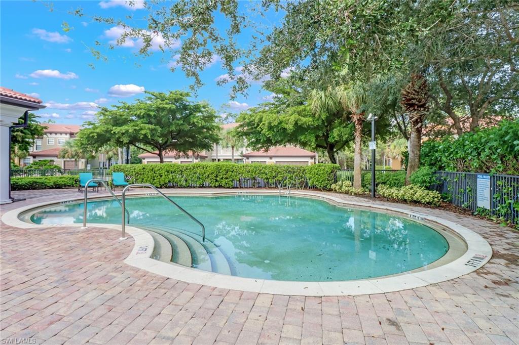 1296 Verde Drive, Unit 3 Naples, FL 34105 - Photo 25 of 31 a view of a swimming pool with a sitting space