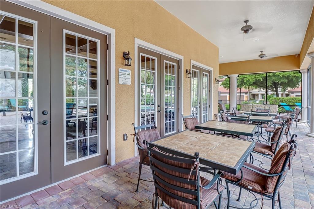1296 Verde Drive, Unit 3 Naples, FL 34105 - Photo 27 of 31 a view of a dining room with furniture large windows and wooden floor
