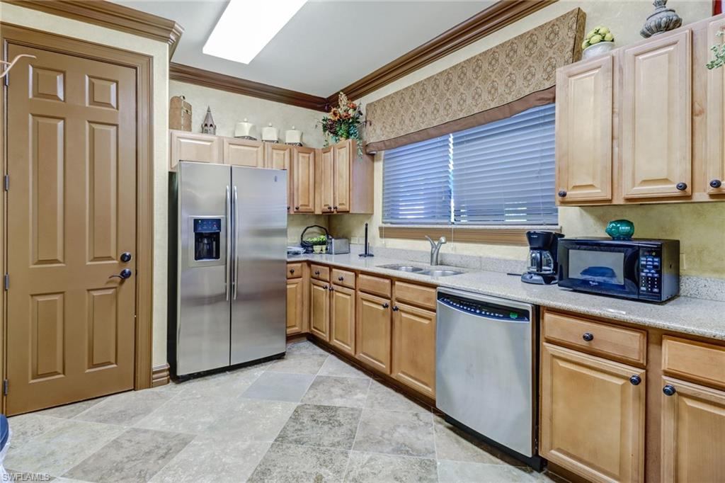1296 Verde Drive, Unit 3 Naples, FL 34105 - Photo 31 of 31 a kitchen with stainless steel appliances granite countertop a refrigerator and a sink