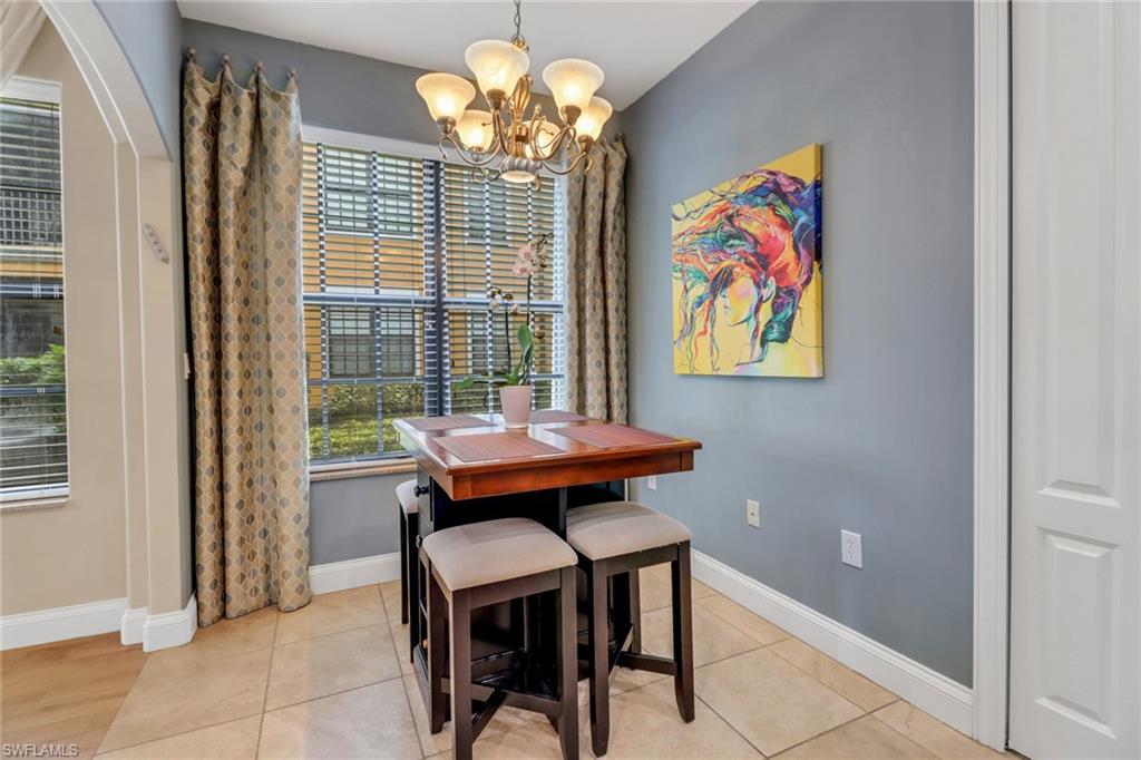 1296 Verde Drive, Unit 3 Naples, FL 34105 - Photo 5 of 31 a view of a dining room with furniture a chandelier and a window