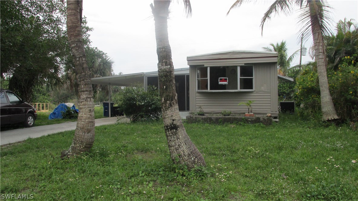 7301 Pinehurst Road Bokeelia, FL 33922 - Photo 1 of 11 a view of house with a yard