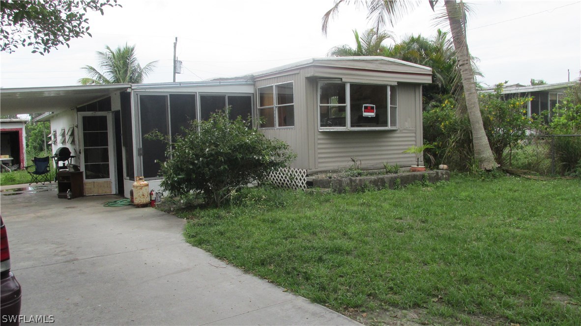 7301 Pinehurst Road Bokeelia, FL 33922 - Photo 2 of 11 a view of a house with porch and garden