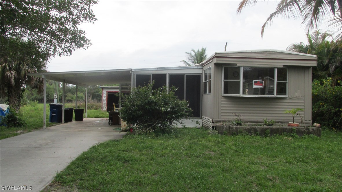 7301 Pinehurst Road Bokeelia, FL 33922 - Photo 3 of 11 a view of a house with a yard