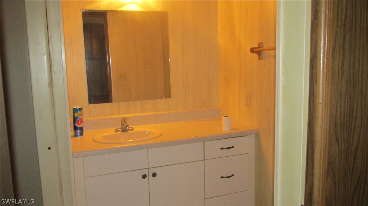 7301 Pinehurst Road Bokeelia, FL 33922 - Photo 7 of 11 a bathroom with a sink and a mirror