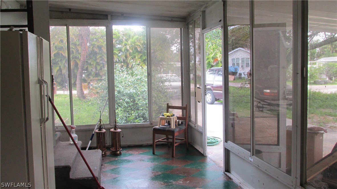 7301 Pinehurst Road Bokeelia, FL 33922 - Photo 10 of 11 a living room with hardwood floor and balcony