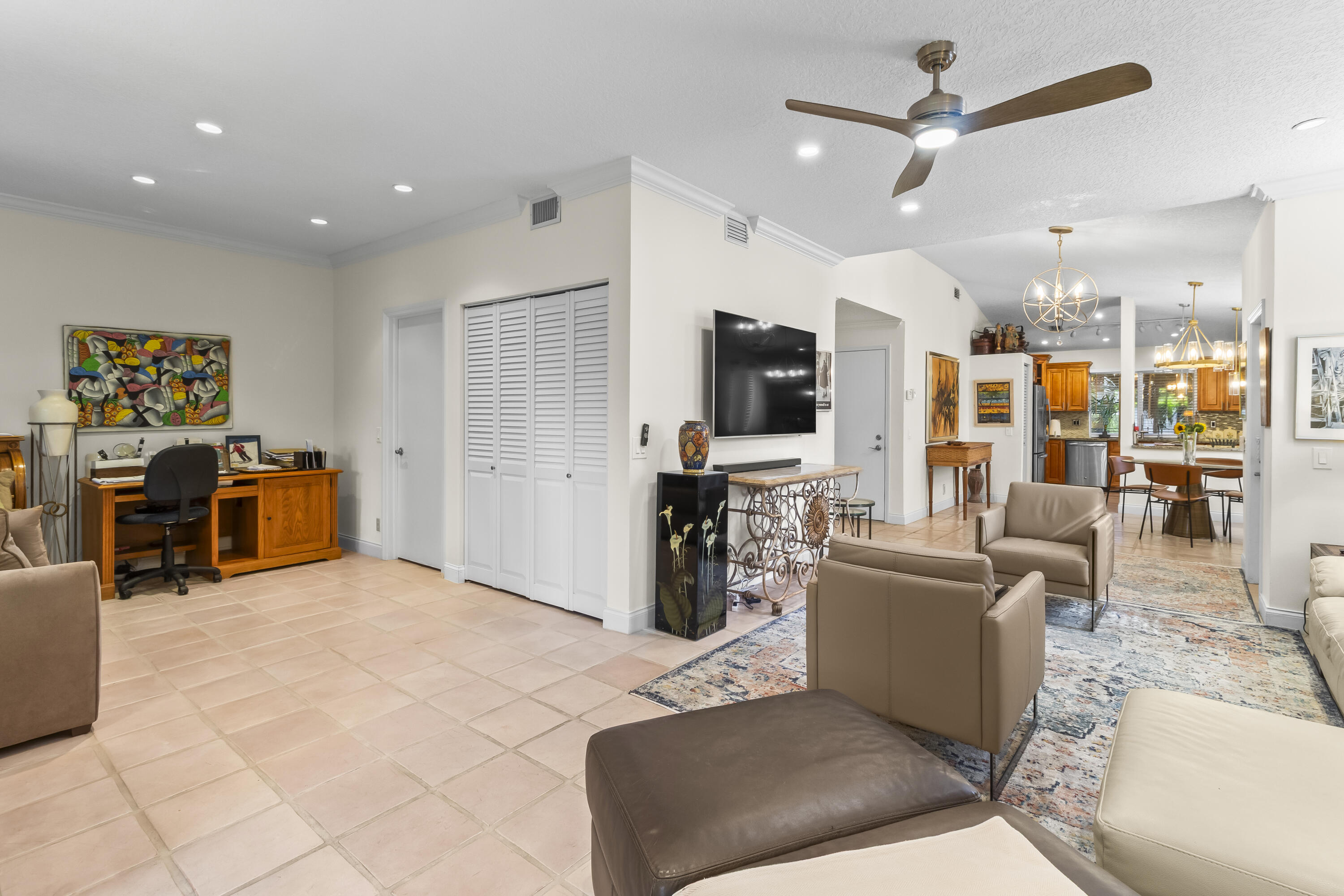6700 Via Regina Boca Raton, FL 33433 - Photo 8 of 15 a living room with furniture a flat screen tv and kitchen view