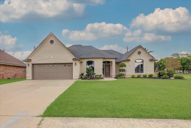 a front view of a house with a yard and garage