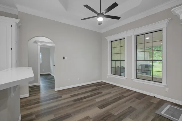 wooden floor in an empty room with a window
