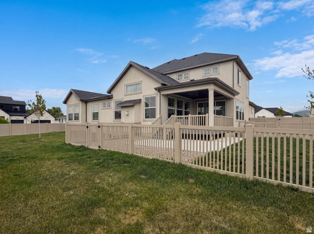 1251 North 2525 West Clinton, UT 84015 - Photo 5 of 30 Expansive backyard featuring a manicured lawn, full perimeter fencing, and a covered patio with a deck