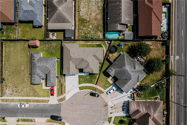 an aerial view of a house with a swimming pool