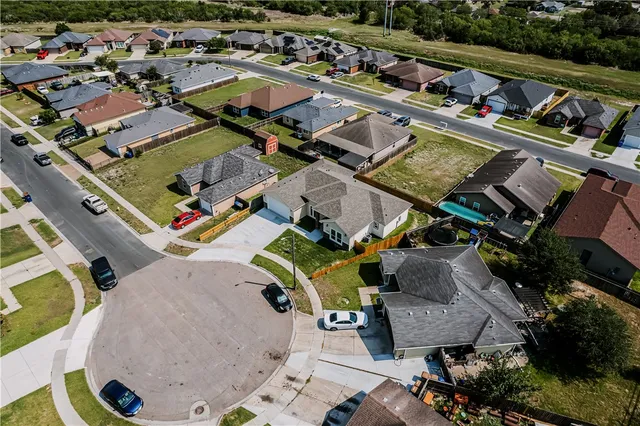 an aerial view of residential houses with outdoor space
