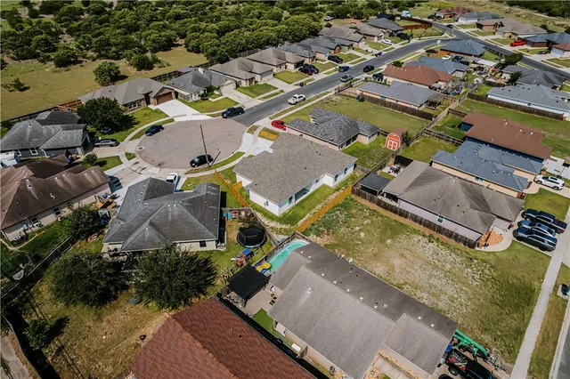 an aerial view of a house with a swimming pool