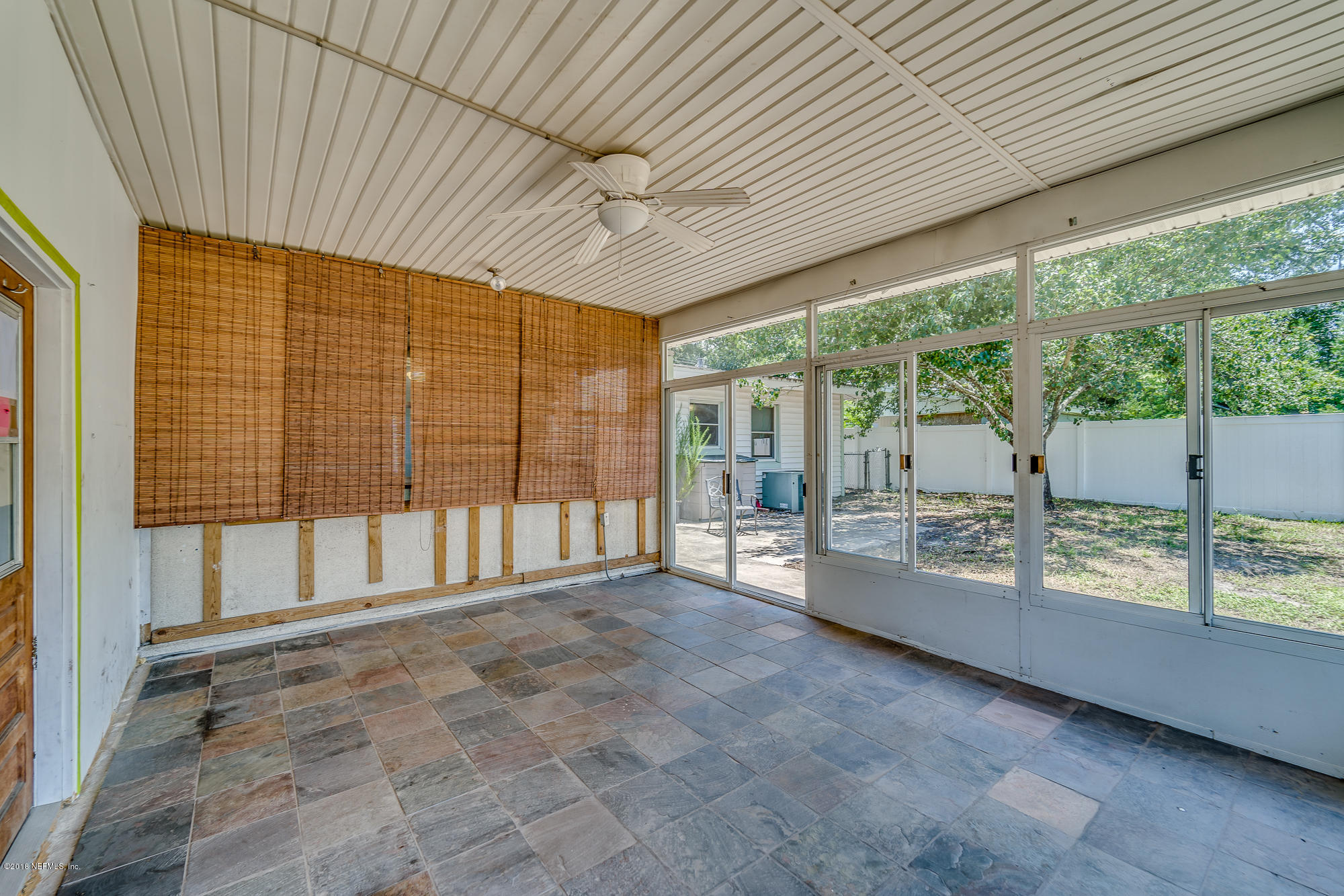 6124 Colgate Road Jacksonville, FL 32217 - Photo 14 of 26 a view of an empty room with wooden floor and balcony