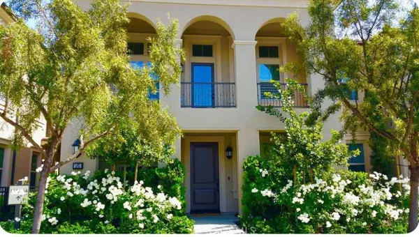 front view of a house with a lot of flower plants
