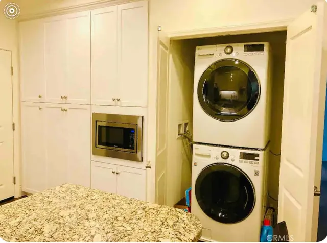 a view of a bedroom with washer and dryer