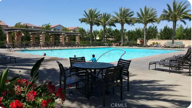 a view of a swimming pool and lounge chairs in patio