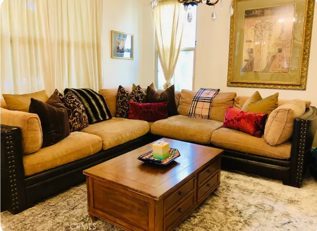 a living room with furniture and a large window