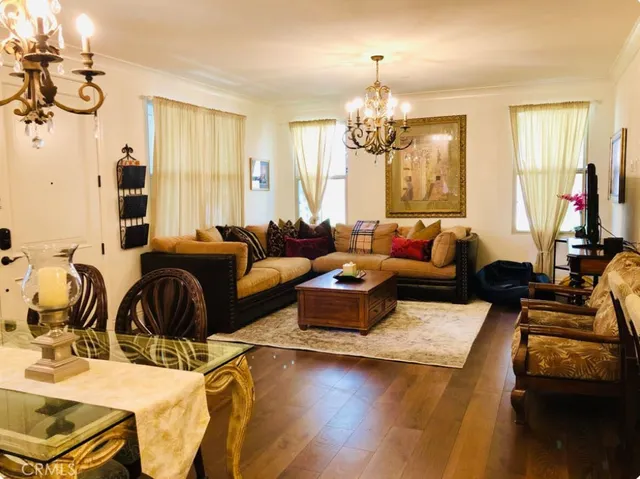 a living room with furniture and a chandelier