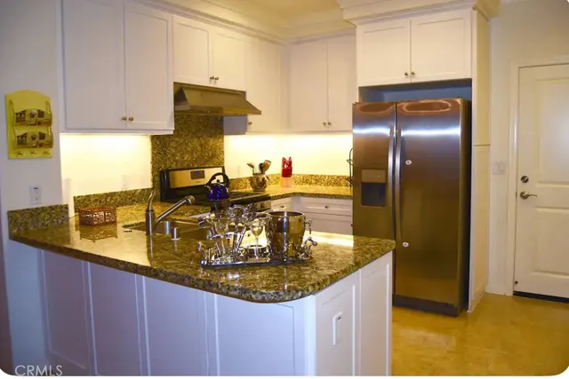 a kitchen with refrigerator and stove