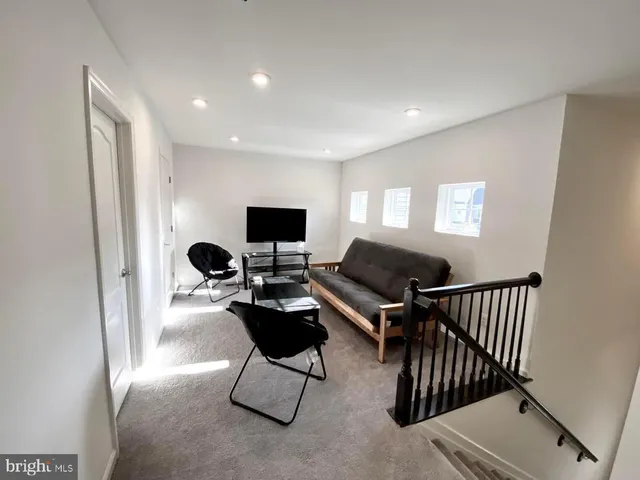 a livingroom with workspace and a couch