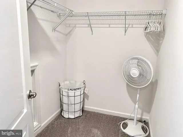 a bathroom with a shower and a fan