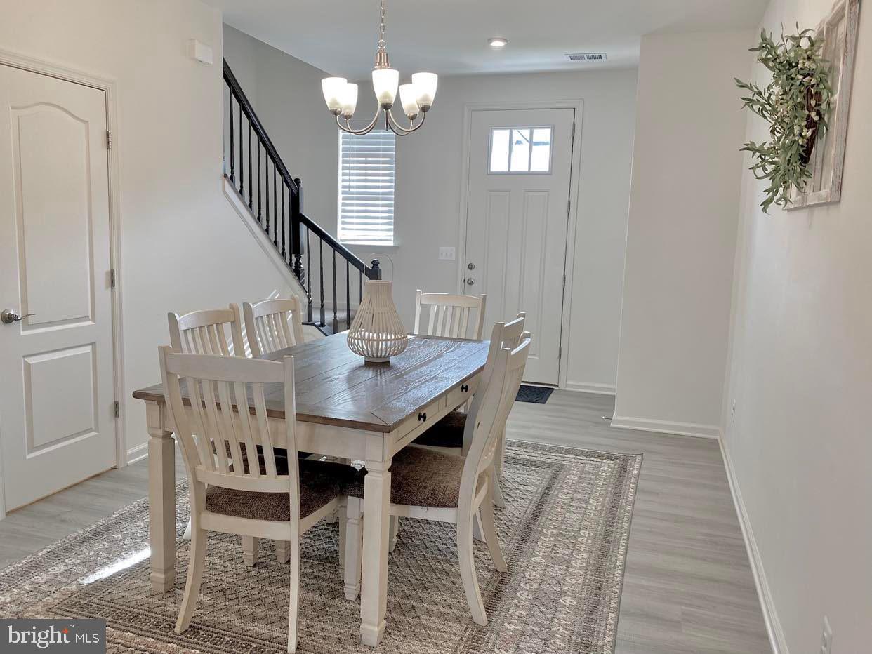 38035 Cross Gate Road Millville, DE 19967 - Photo 2 of 22 a view of a dining room with furniture and wooden floor