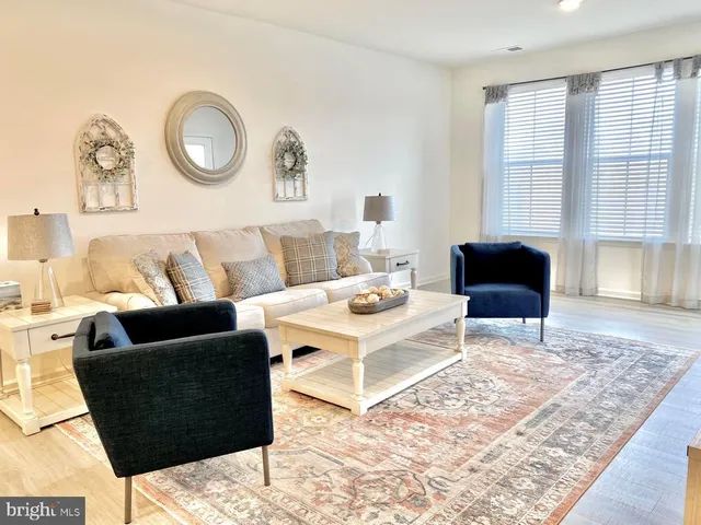 a living room with furniture and a rug