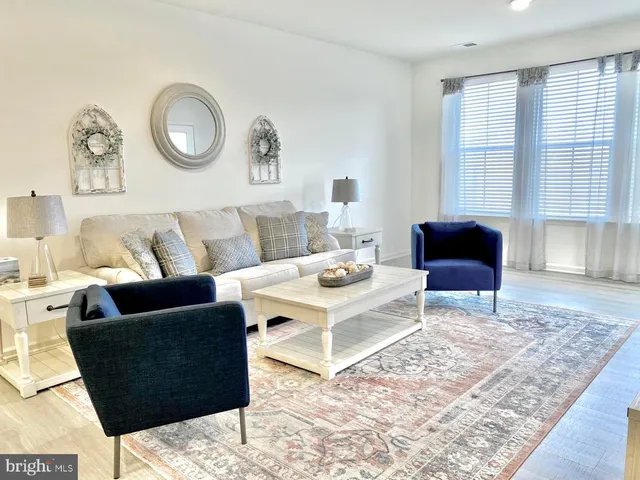 a living room with furniture and a rug