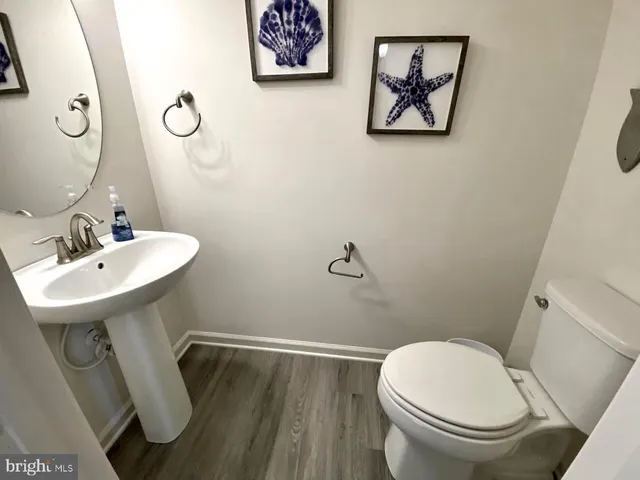 a bathroom with a toilet a sink and mirror