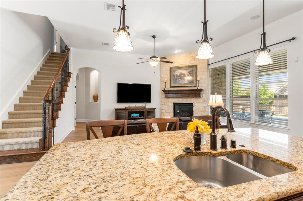 1112 Rhett Drive Colleyville, TX 76034 - Photo 12 of 40 a kitchen view with granite countertop a sink and a flat screen tv