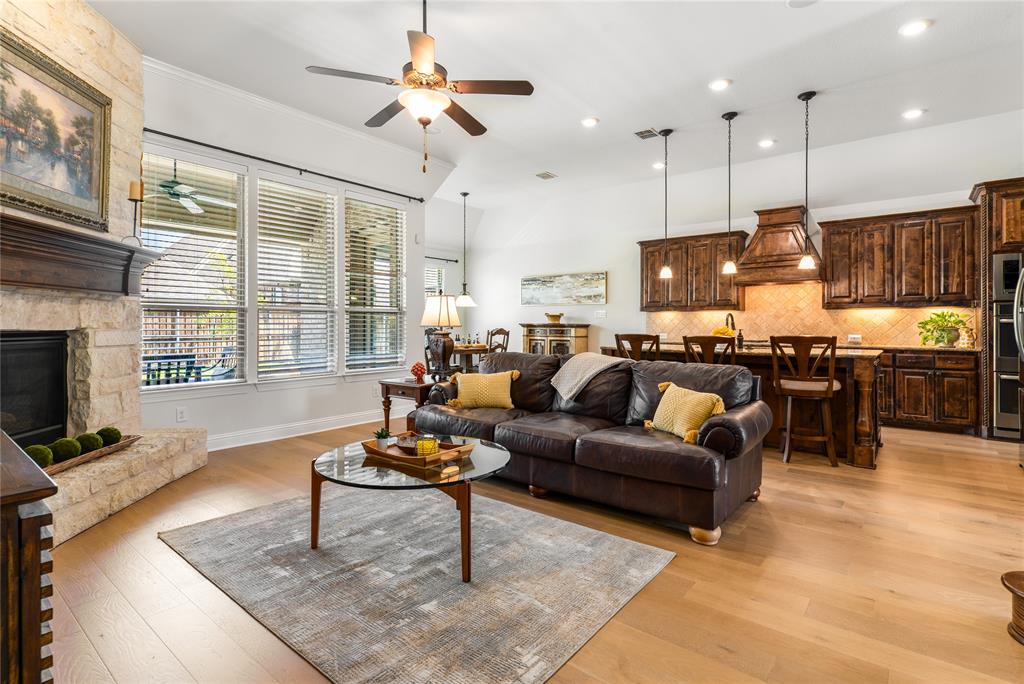 1112 Rhett Drive Colleyville, TX 76034 - Photo 14 of 40 a living room with furniture kitchen view and a fireplace