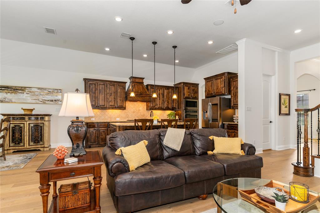 1112 Rhett Drive Colleyville, TX 76034 - Photo 15 of 40 a living room with furniture kitchen view and a fireplace