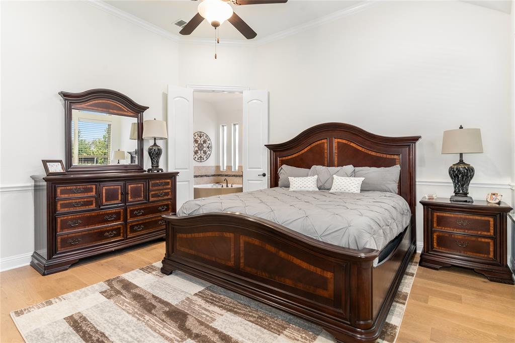 1112 Rhett Drive Colleyville, TX 76034 - Photo 19 of 40 a bedroom with a bed and a dresser