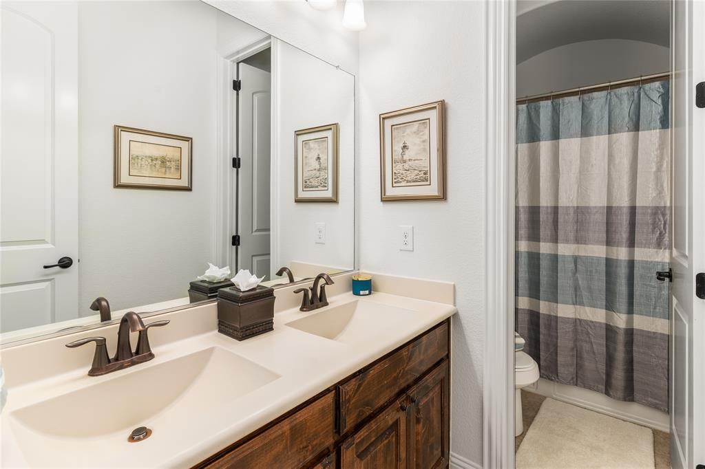 1112 Rhett Drive Colleyville, TX 76034 - Photo 22 of 40 a bathroom with a sink a toilet and shower
