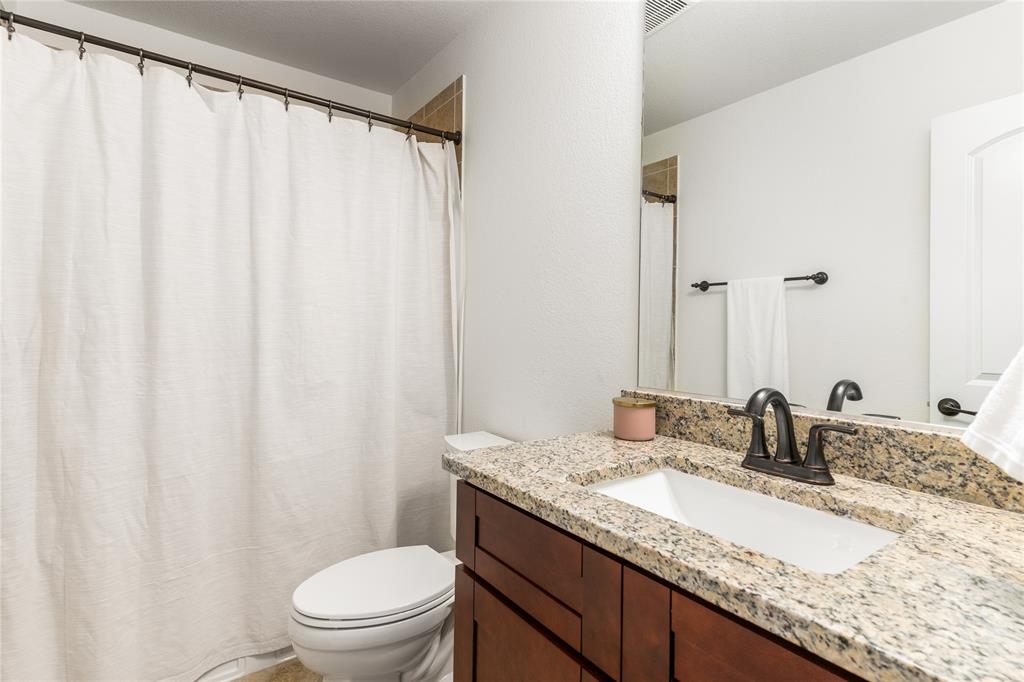 1112 Rhett Drive Colleyville, TX 76034 - Photo 23 of 40 a bathroom with a granite countertop sink and a mirror