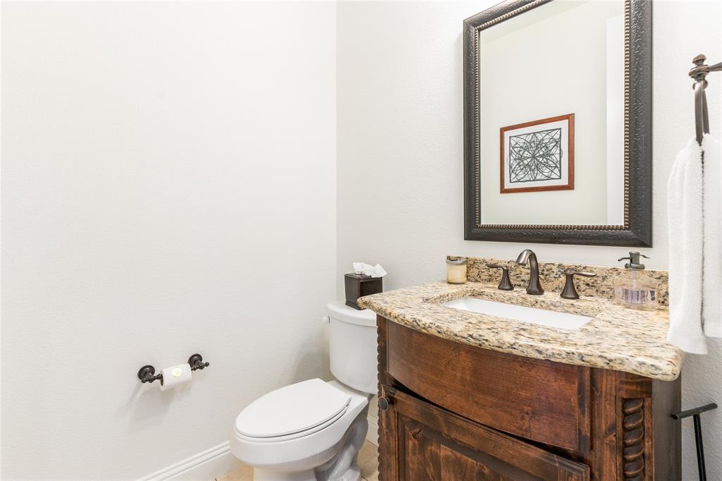 1112 Rhett Drive Colleyville, TX 76034 - Photo 24 of 40 a bathroom with a granite countertop toilet and a sink