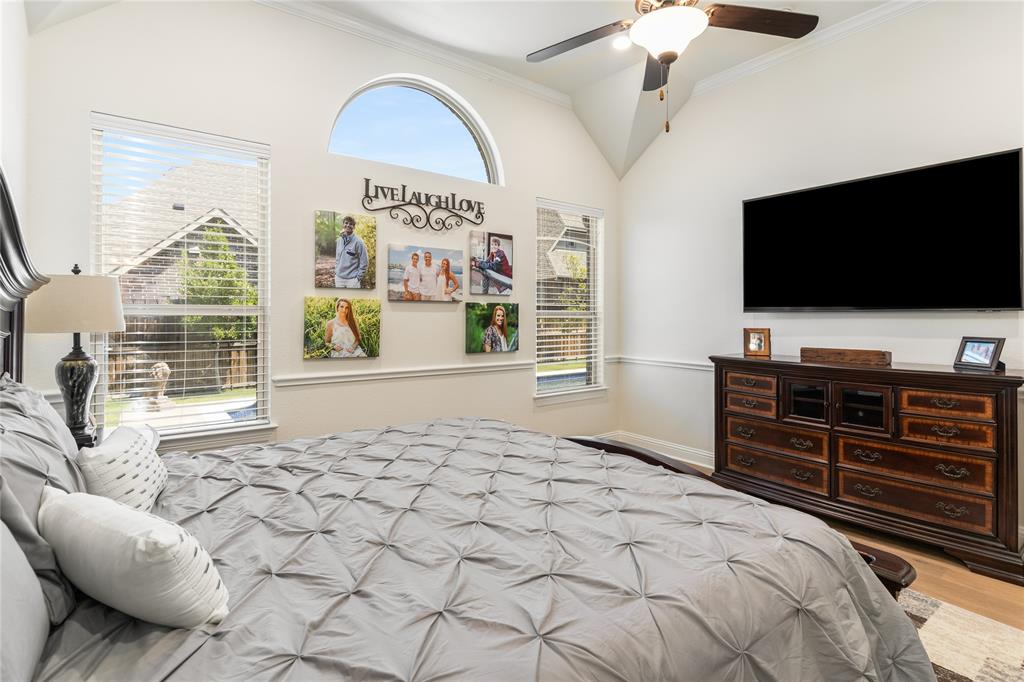 1112 Rhett Drive Colleyville, TX 76034 - Photo 25 of 40 a bedroom with a bed and a flat screen tv