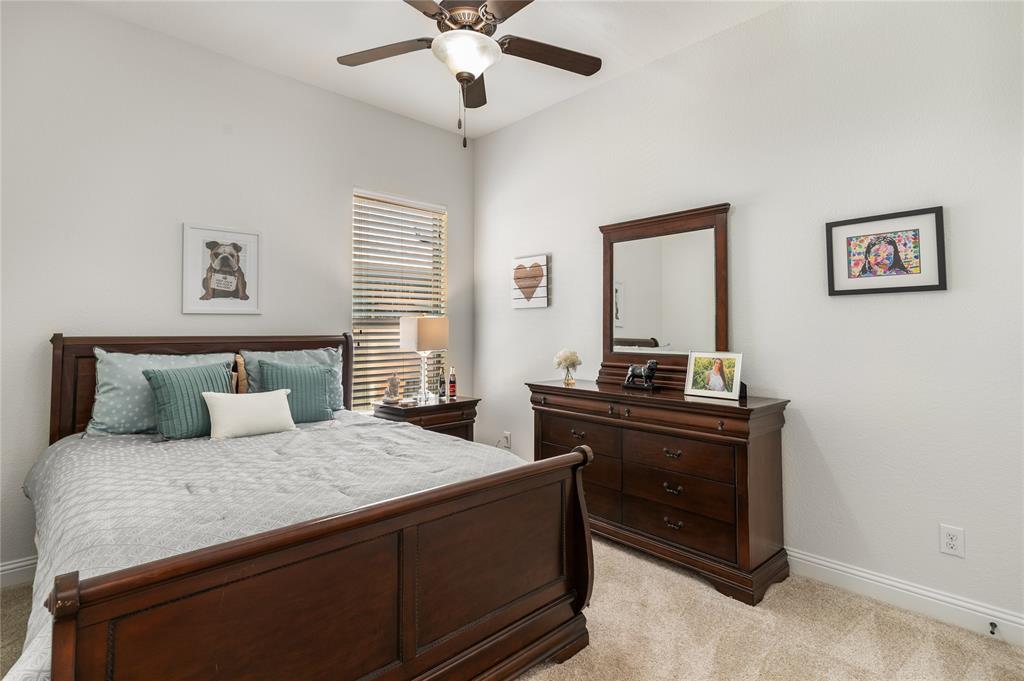 1112 Rhett Drive Colleyville, TX 76034 - Photo 26 of 40 a bedroom with a bed and a chandelier