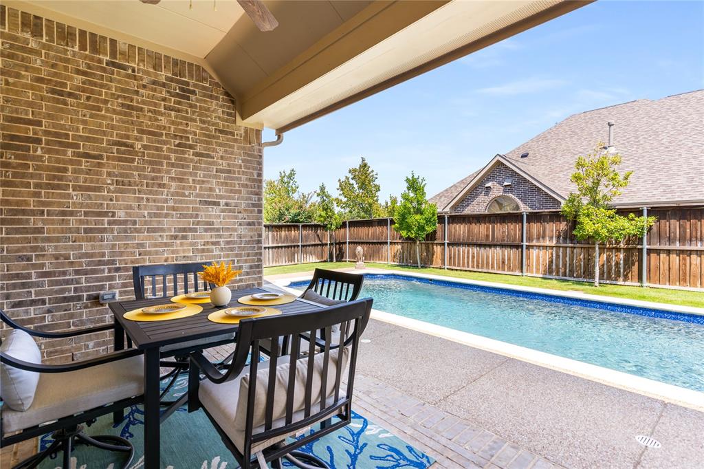 1112 Rhett Drive Colleyville, TX 76034 - Photo 33 of 40 a view of a patio with a table and chairs