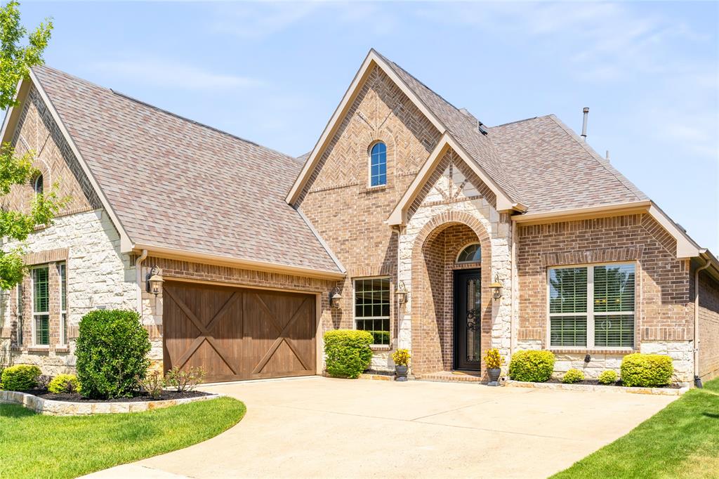 1112 Rhett Drive Colleyville, TX 76034 - Photo 39 of 40 a front view of a house with a yard and potted plants