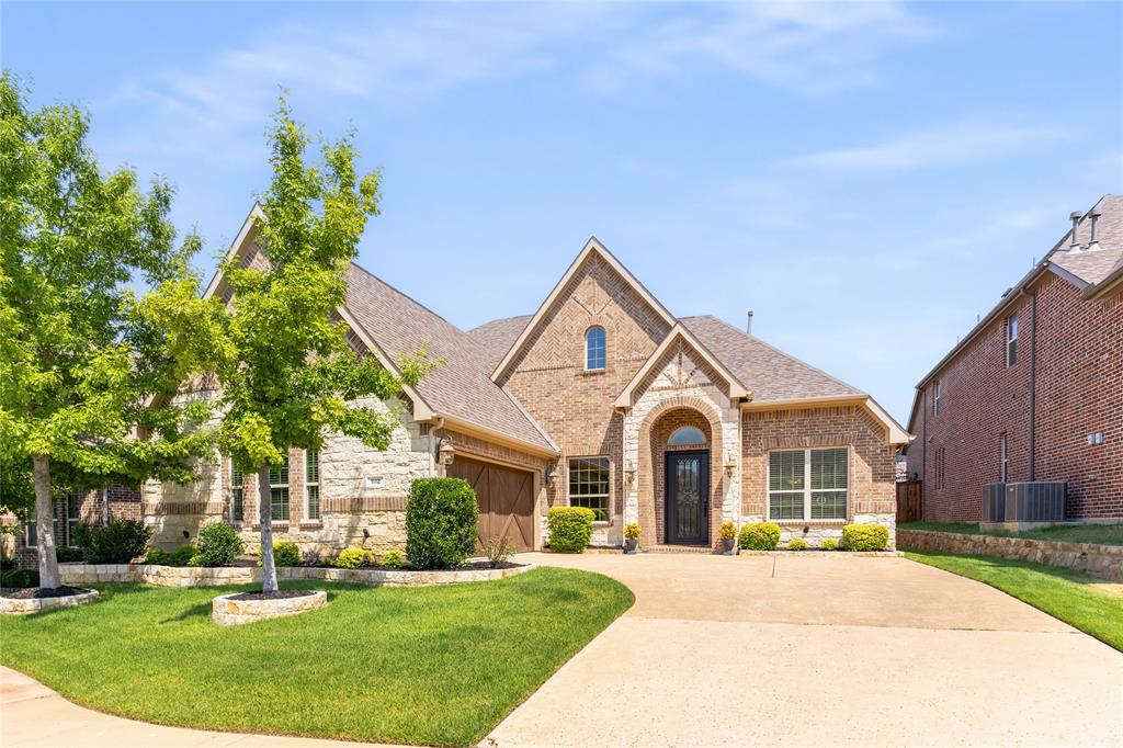 1112 Rhett Drive Colleyville, TX 76034 - Photo 6 of 40 a front view of a house with a garden