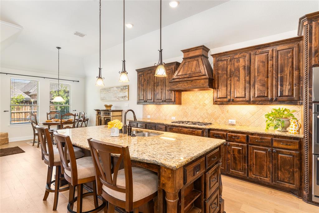 1112 Rhett Drive Colleyville, TX 76034 - Photo 10 of 40 a kitchen with stainless steel appliances granite countertop a stove a sink dishwasher and a wooden cabinets