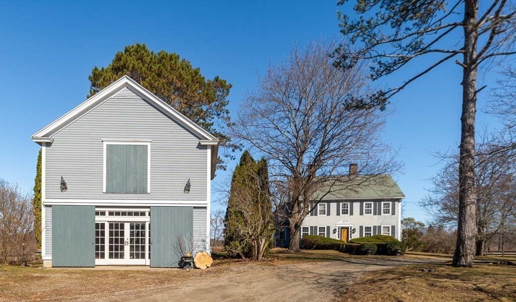 6 Northgate Road Ipswich, MA 01938 - Photo 36 of 42 a view of a big house with large windows and a large tree