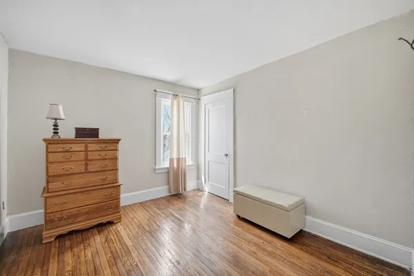 a view of room with wooden floor