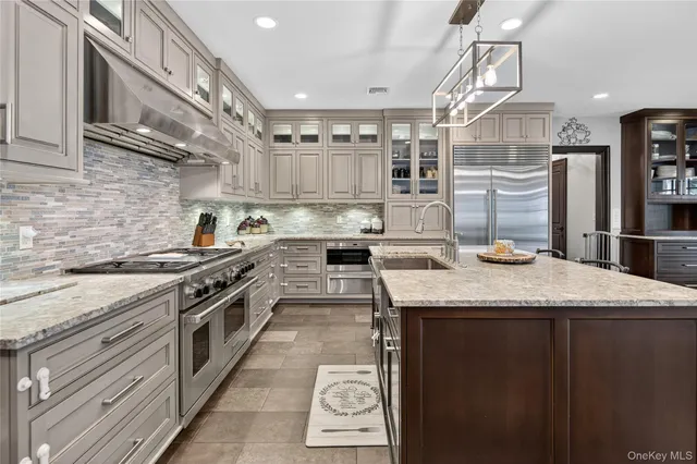 a kitchen with stainless steel appliances granite countertop a stove and a sink
