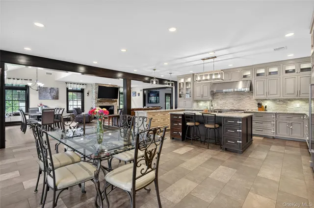a kitchen with stainless steel appliances kitchen island granite countertop a refrigerator and cabinets